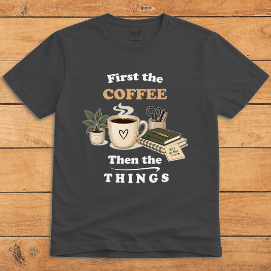 Dark heather coffee T-shirt with a steaming mug and the words “First the Coffee, Then the Things”