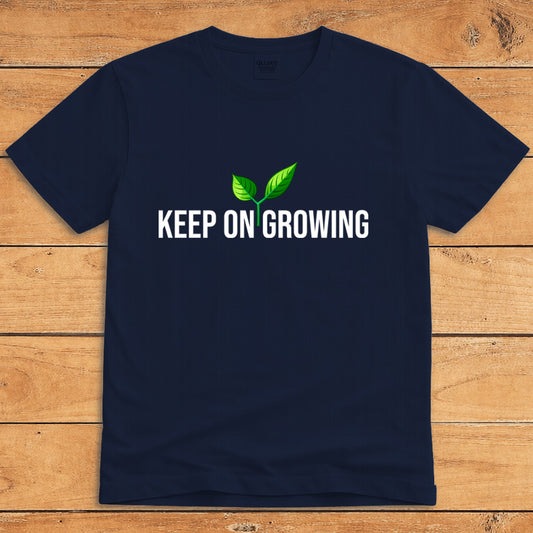 Navy plant lover T-shirt featuring a green sprout and the words “Keep on Growing”