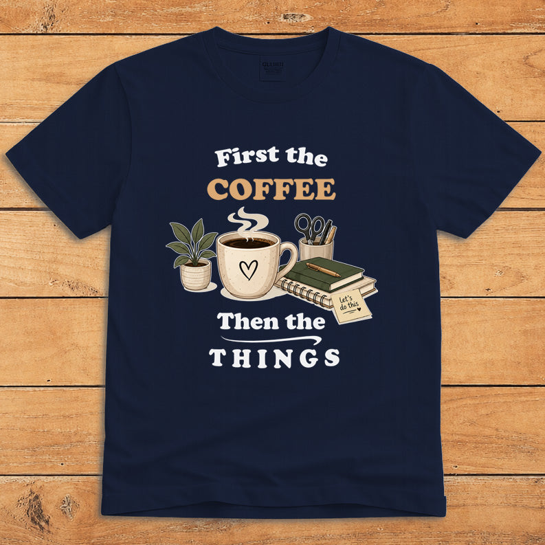 Navy coffee T-shirt with a steaming mug and the words “First the Coffee, Then the Things”