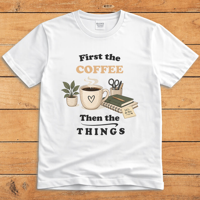 White coffee T-shirt with a steaming mug and the words “First the Coffee, Then the Things”