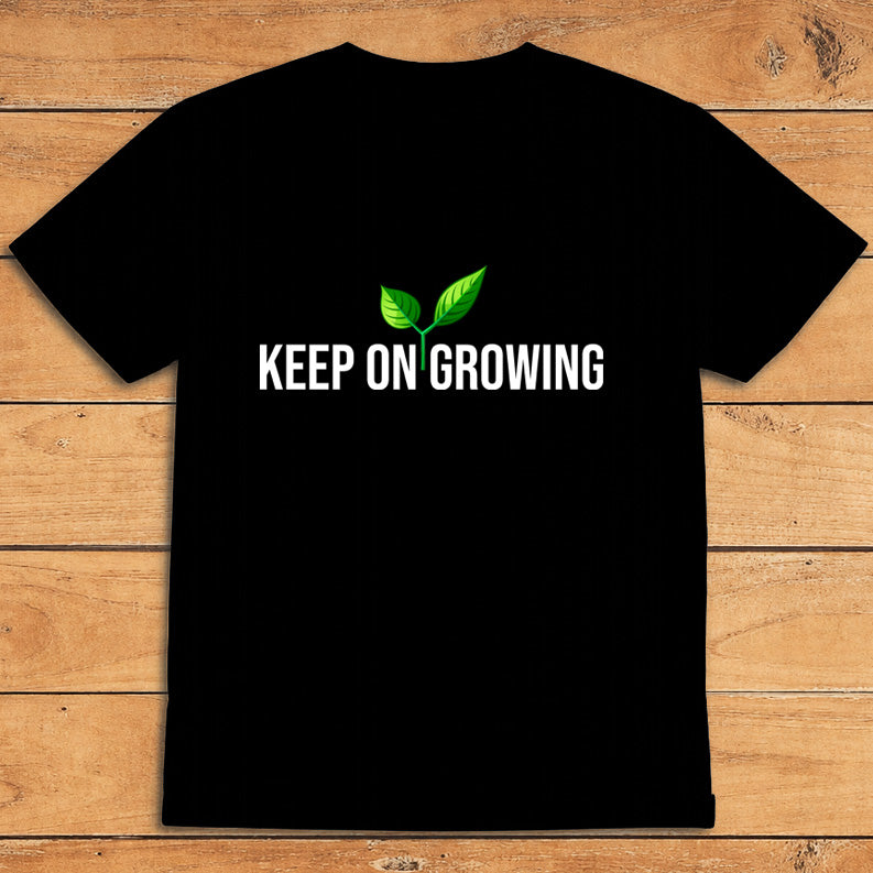 Black plant lover T-shirt featuring a green sprout and the words “Keep on Growing”