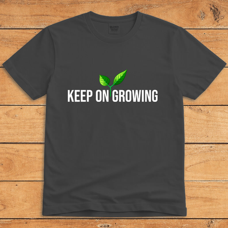 Dark heather plant lover T-shirt featuring a green sprout and the words “Keep on Growing”