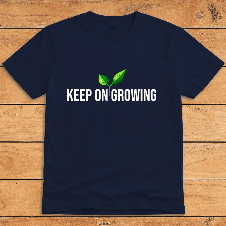 Navy plant lover T-shirt featuring a green sprout and the words “Keep on Growing”