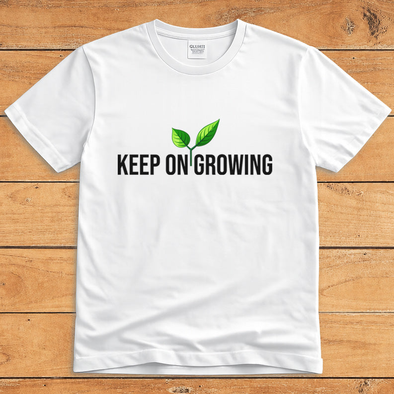 White plant lover T-shirt featuring a green sprout and the words “Keep on Growing”