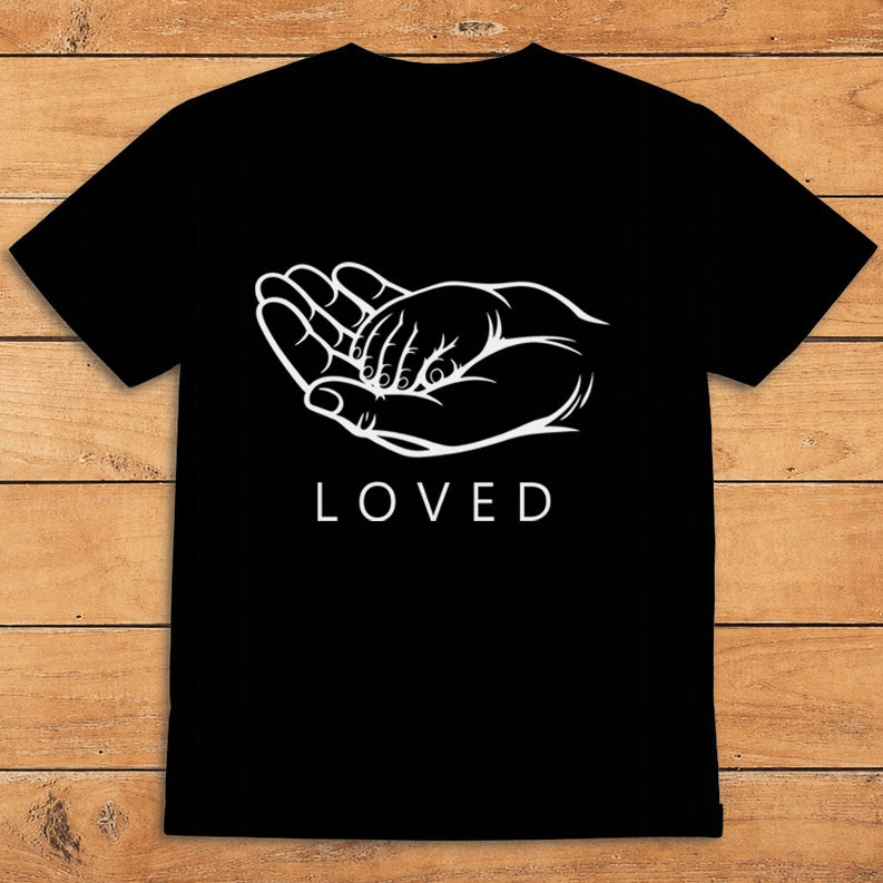 Black parent T-shirt showing a grown-up holding a child’s hand alongside the word “LOVED”