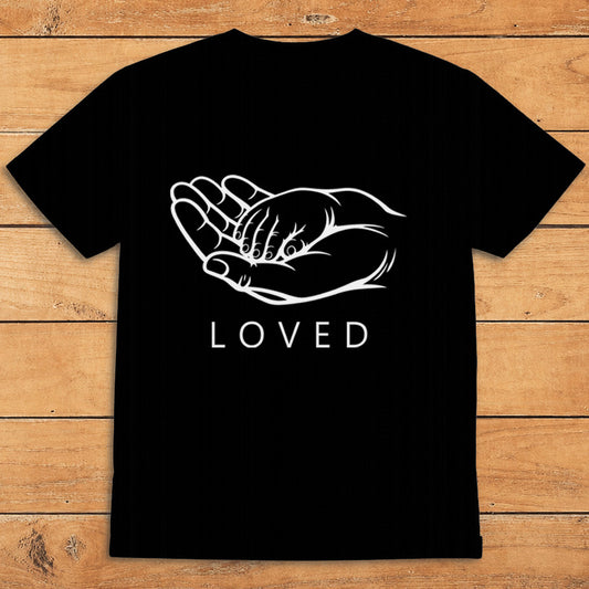 Black parent T-shirt showing a grown-up holding a child’s hand alongside the word “LOVED”