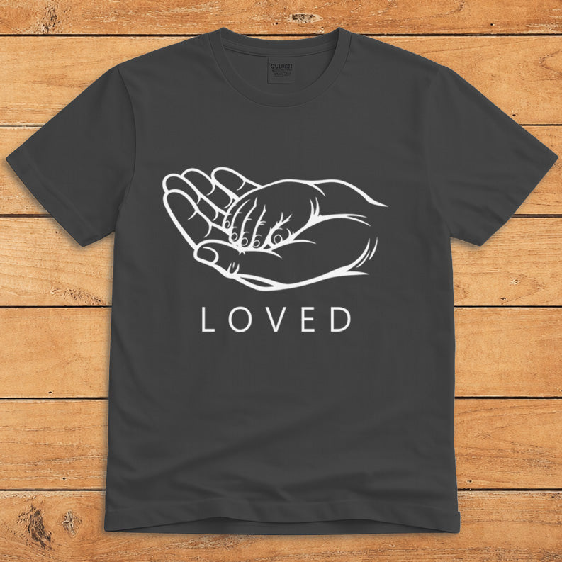 Dark heather parent T-shirt showing a grown-up holding a child’s hand alongside the word “LOVED”