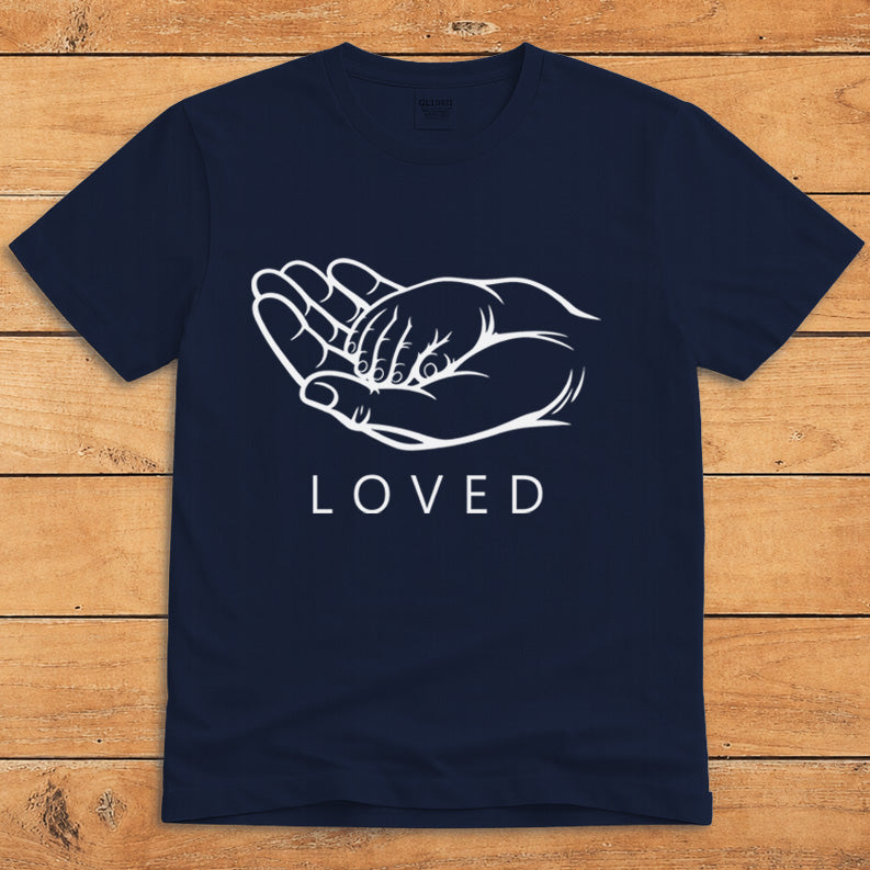 Navy parent T-shirt showing a grown-up holding a child’s hand alongside the word “LOVED”