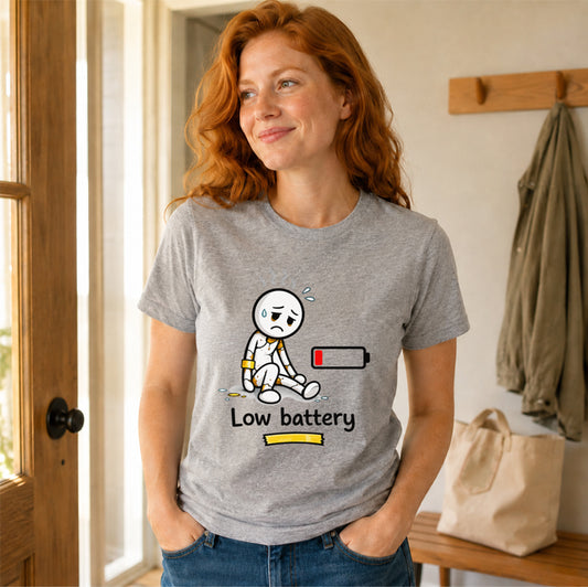 A woman with red hear wearing the sport grey colored Low Battery unisex T-shirt, with a minimalist design