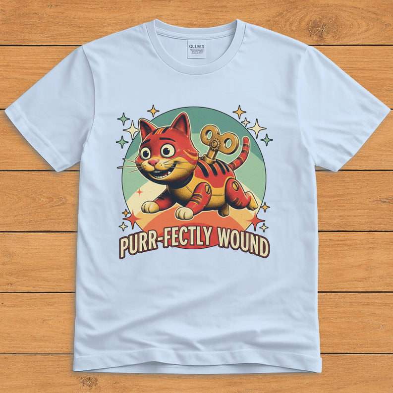 Light blue funny cat T-shirt featuring a retro wind-up toy and the words “Purr-fectly Wound”
