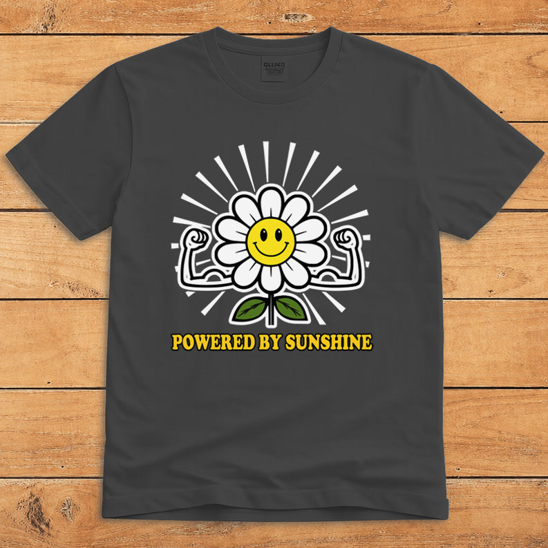 Dark heather sunshine T-shirt featuring a smiling daisy flexing its arms and the words “Powered by Sunshine”